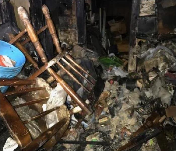 Fire damaged room and fire damaged kitchen chairs