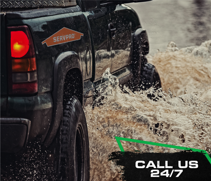 call us, servpro poster with truck splashing thru water