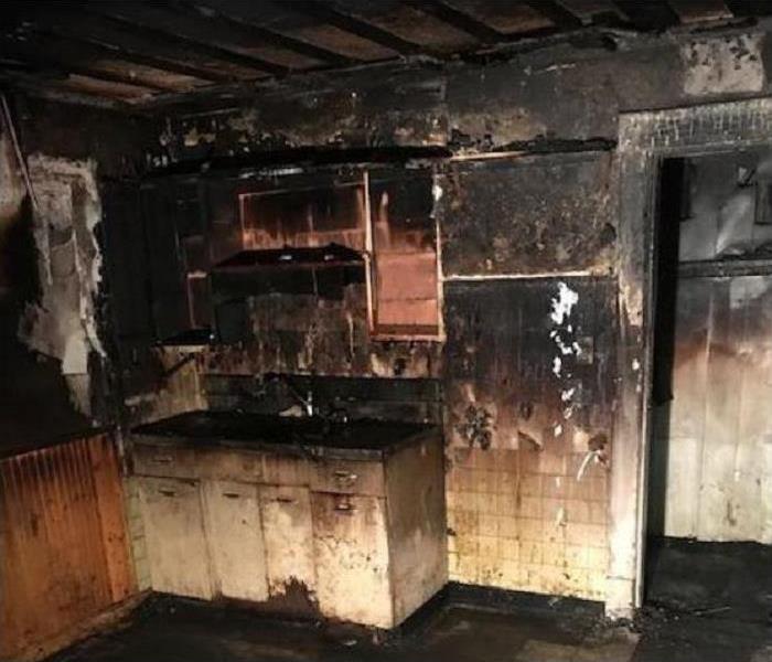 Fire damaged kitchen.  Heavily smoke and soot damaged walls.